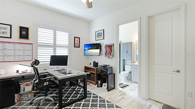 office area with ceiling fan and light hardwood / wood-style flooring