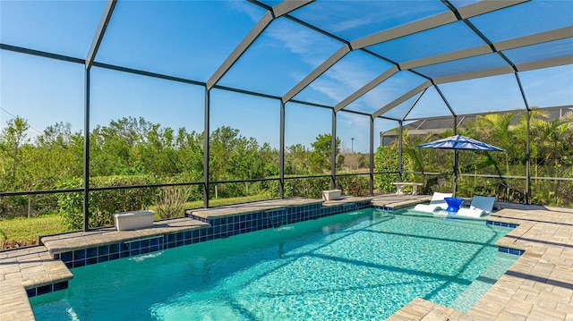 view of swimming pool featuring pool water feature, a lanai, and a patio area