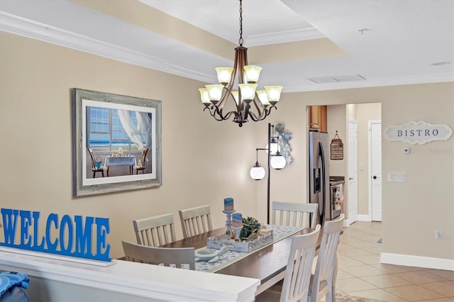 tiled dining space featuring a chandelier, ornamental molding, and a raised ceiling