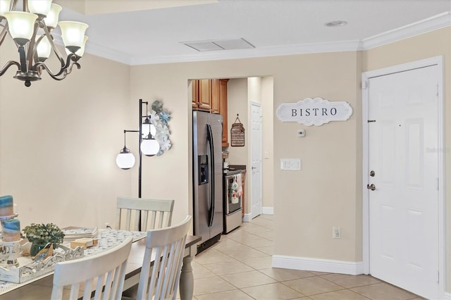 tiled dining area featuring ornamental molding and a chandelier