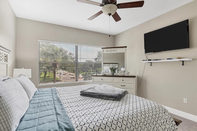 bedroom featuring ceiling fan and carpet