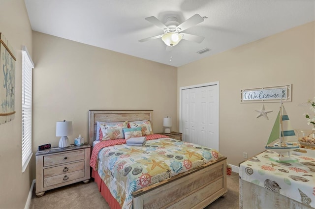 carpeted bedroom featuring a closet and ceiling fan