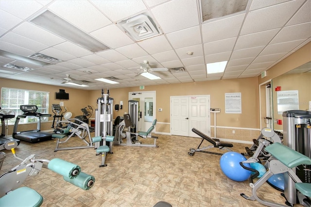 workout area with a drop ceiling and ceiling fan