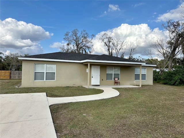 single story home with a patio area and a front lawn