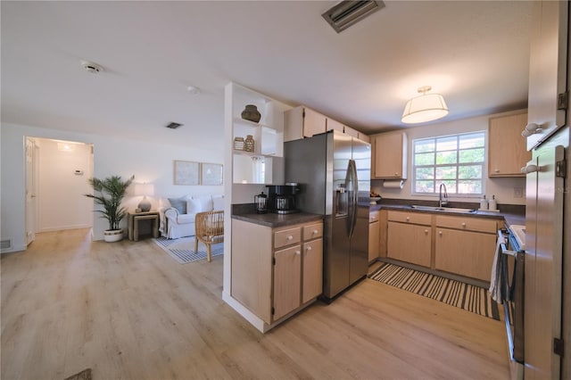 kitchen featuring light hardwood / wood-style floors, stainless steel appliances, light brown cabinetry, and sink