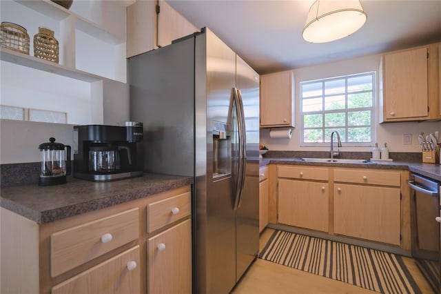 kitchen featuring light brown cabinetry, sink, and appliances with stainless steel finishes