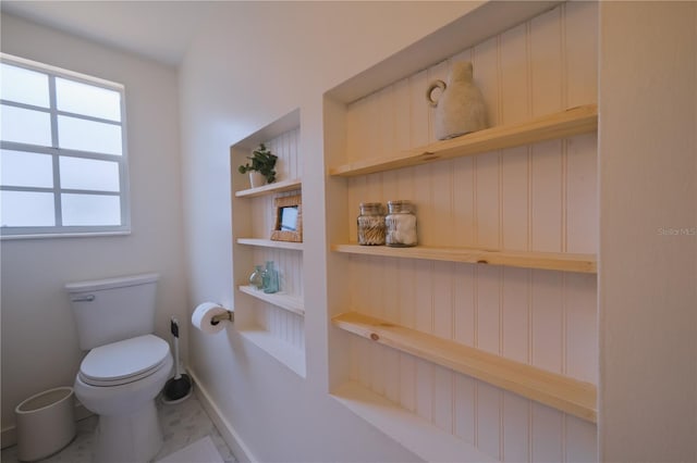 bathroom featuring built in features and toilet