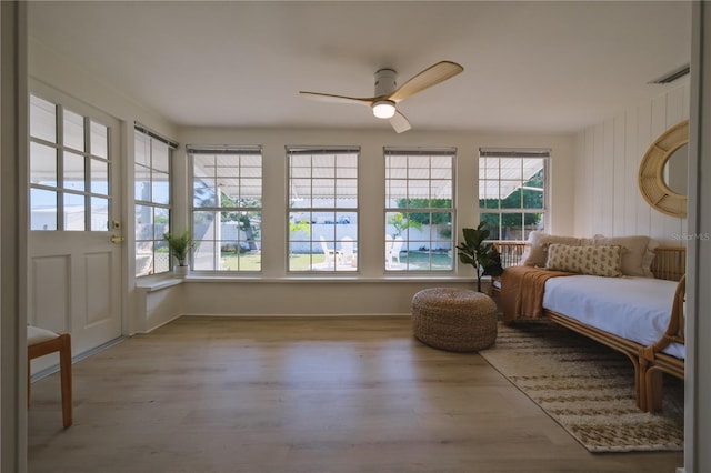 sunroom / solarium featuring ceiling fan