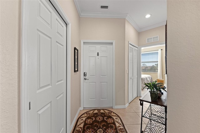 entryway featuring light tile patterned flooring and ornamental molding