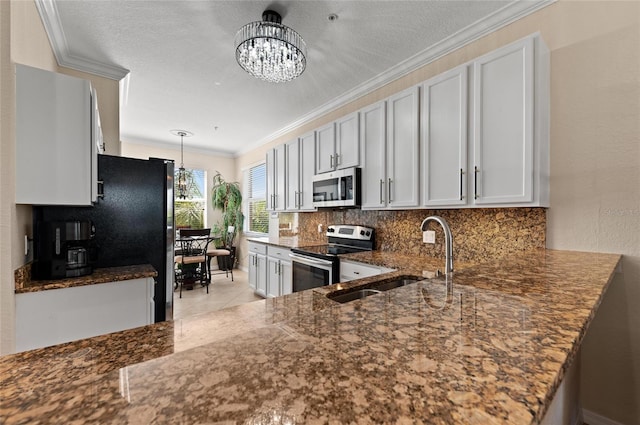 kitchen featuring an inviting chandelier, sink, white cabinetry, and stainless steel appliances