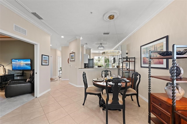 tiled dining room featuring ornamental molding