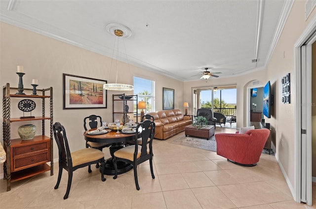 tiled dining area with ceiling fan and ornamental molding