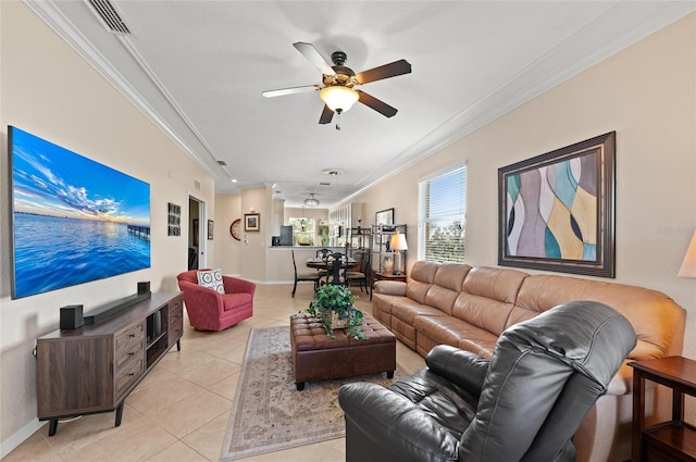 living room featuring crown molding, ceiling fan, and light tile patterned floors