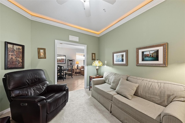 living room featuring ornamental molding, light tile patterned floors, and ceiling fan