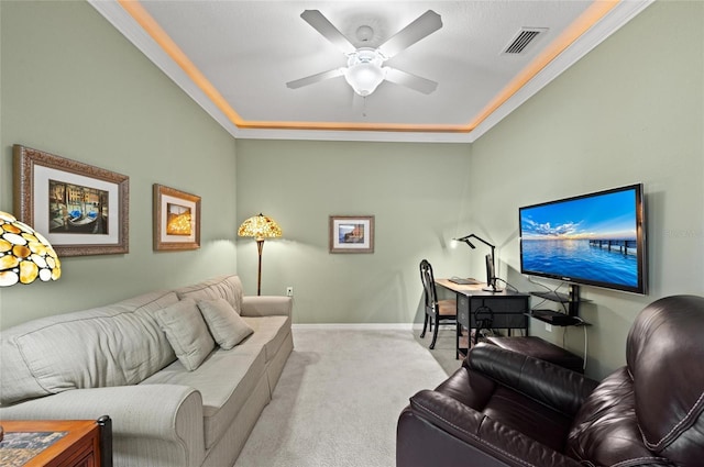 living room with ornamental molding, light colored carpet, and ceiling fan