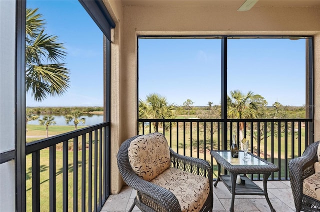 sunroom / solarium with plenty of natural light and a water view