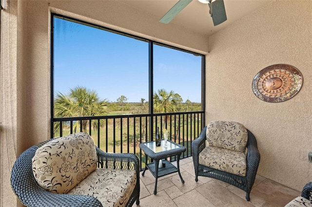 sunroom / solarium featuring ceiling fan