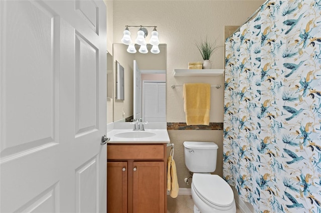 bathroom with tile patterned flooring, vanity, a shower with shower curtain, and toilet