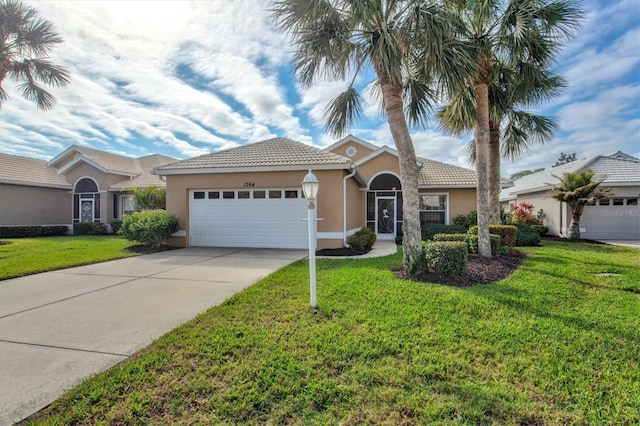 view of front of property featuring a garage and a front lawn