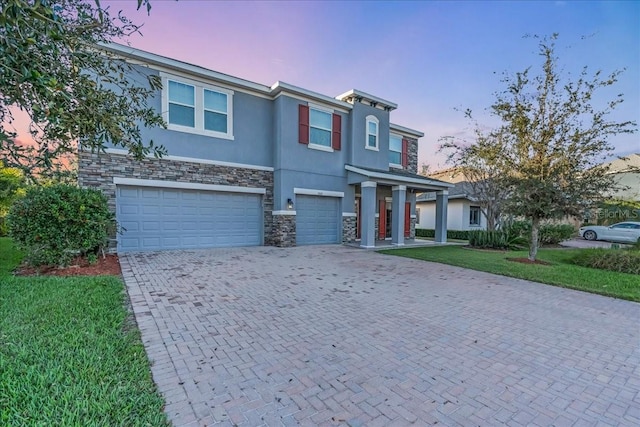 view of front of home featuring a yard and a garage