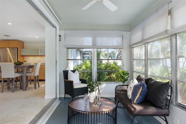 sunroom / solarium with ceiling fan and a healthy amount of sunlight