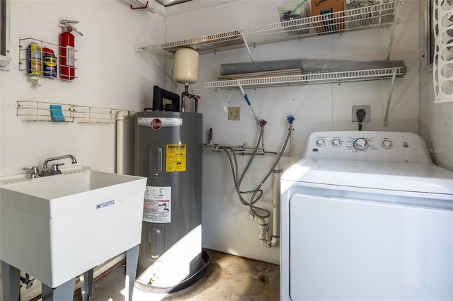 clothes washing area featuring washer / dryer, electric water heater, and sink