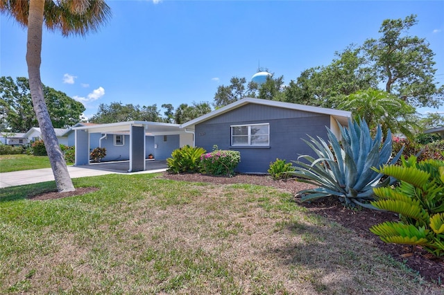 2321 Terry Ln, Sarasota, FL 34231 - view of front of home with an attached carport, a front lawn, driveway, and concrete block siding