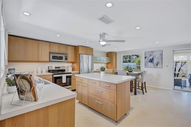 2321 Terry Ln, Sarasota, FL 34231 - kitchen with appliances with stainless steel finishes, recessed lighting, light countertops, baseboards, and light brown cabinets