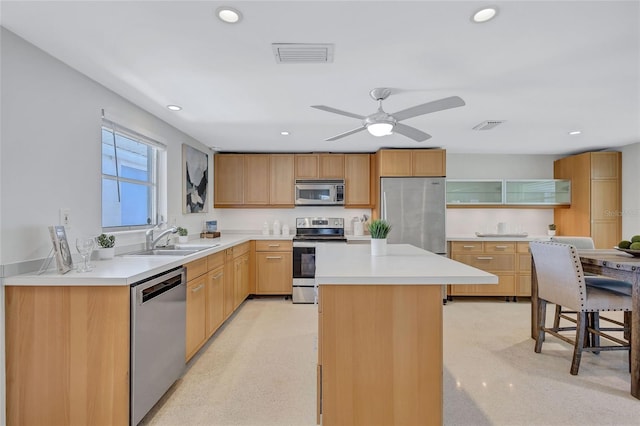 2321 Terry Ln, Sarasota, FL 34231 - kitchen featuring stainless steel appliances, a sink, recessed lighting, a center island, and light countertops