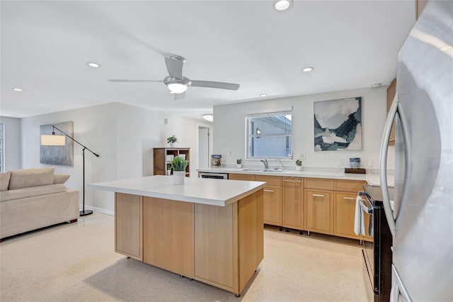 2321 Terry Ln, Sarasota, FL 34231 - kitchen with range with electric stovetop, freestanding refrigerator, light brown cabinets, a sink, and recessed lighting