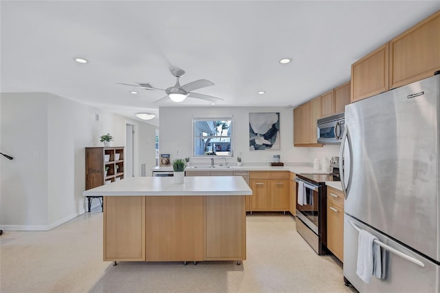 2321 Terry Ln, Sarasota, FL 34231 - kitchen featuring stainless steel appliances, light brown cabinetry, light countertops, recessed lighting, and a kitchen island