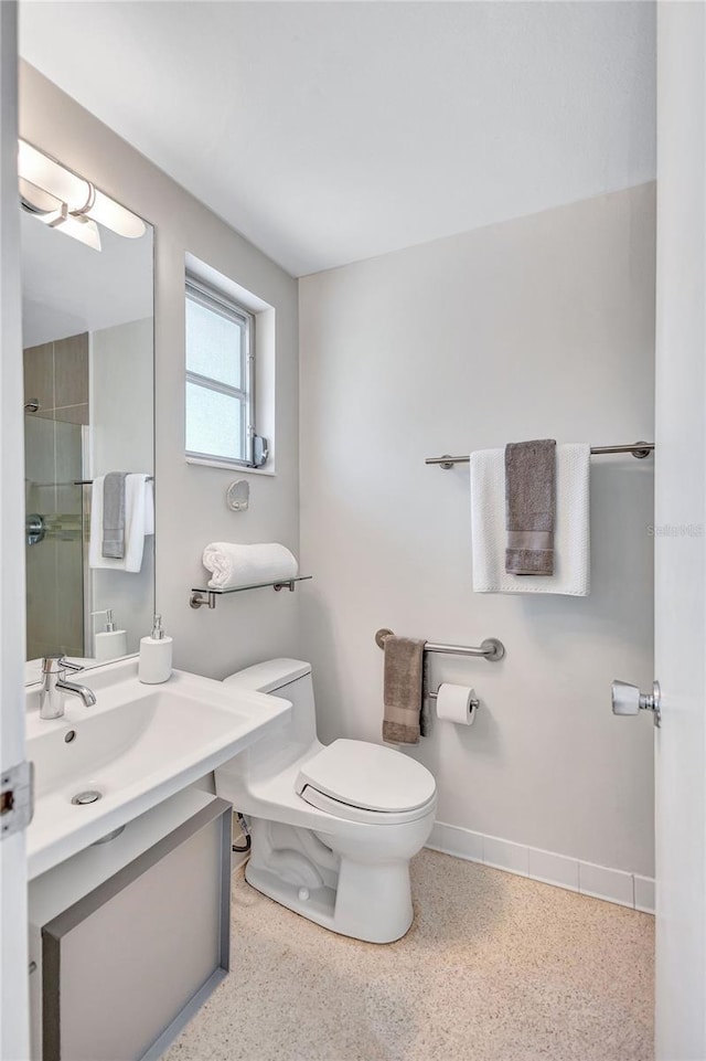 2321 Terry Ln, Sarasota, FL 34231 - full bathroom with toilet, speckle patterned floor, vanity, and a shower