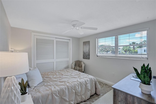 2321 Terry Ln, Sarasota, FL 34231 - bedroom with a closet, baseboards, carpet, and a ceiling fan