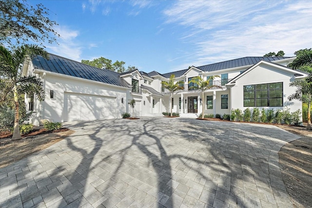 view of front of property with a balcony and a garage