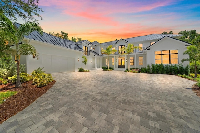 656 Tropical Cir, Sarasota, FL 34242 - view of front of home with stucco siding, a standing seam roof, metal roof, and a garage