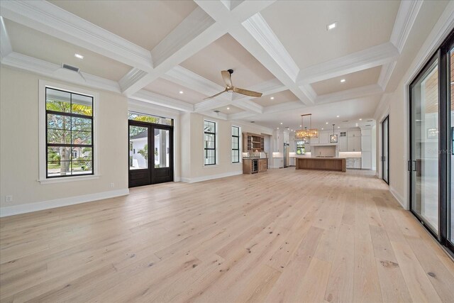 656 Tropical Cir, Sarasota, FL 34242 - unfurnished living room featuring light wood-style floors, coffered ceiling, baseboards, and beamed ceiling
