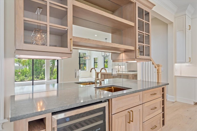 656 Tropical Cir, Sarasota, FL 34242 - kitchen with stone countertops, a sink, wine cooler, and glass insert cabinets