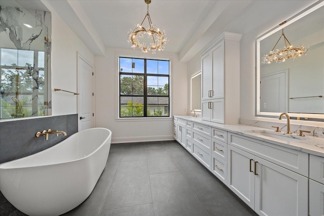 656 Tropical Cir, Sarasota, FL 34242 - full bath with an inviting chandelier, a sink, double vanity, baseboards, and a freestanding tub