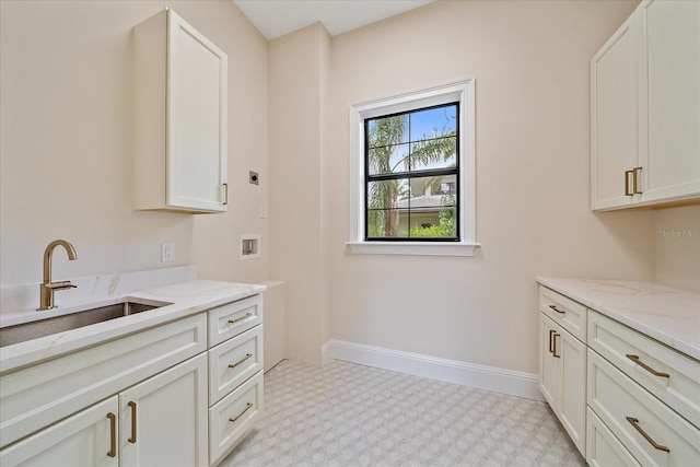 656 Tropical Cir, Sarasota, FL 34242 - washroom featuring washer hookup, electric dryer hookup, cabinet space, a sink, and light floors