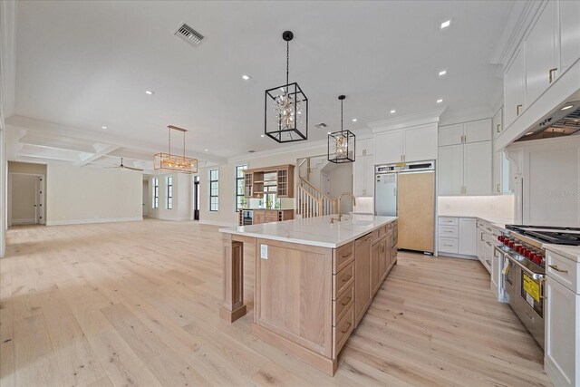 656 Tropical Cir, Sarasota, FL 34242 - kitchen with visible vents, fridge, open floor plan, range with two ovens, and a sink