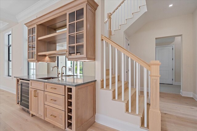 656 Tropical Cir, Sarasota, FL 34242 - kitchen with wine cooler, open shelves, and light wood-style flooring
