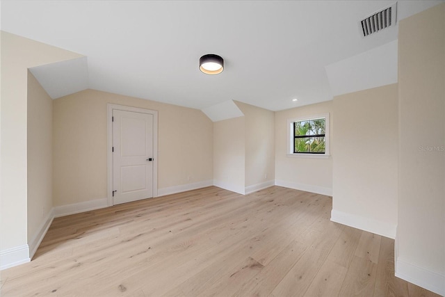 656 Tropical Cir, Sarasota, FL 34242 - additional living space with visible vents, baseboards, lofted ceiling, and light wood-type flooring