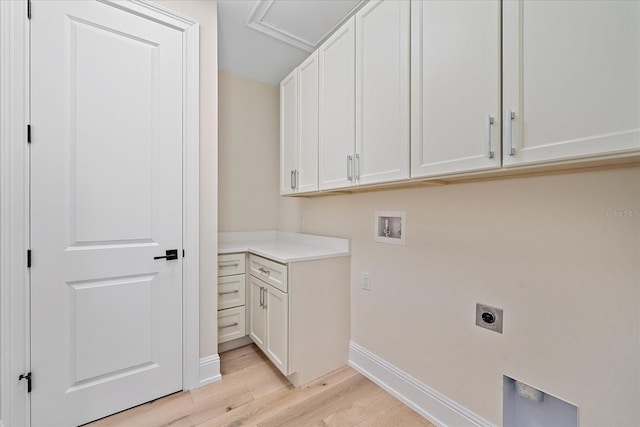 656 Tropical Cir, Sarasota, FL 34242 - washroom with baseboards, cabinet space, hookup for an electric dryer, light wood-style flooring, and washer hookup