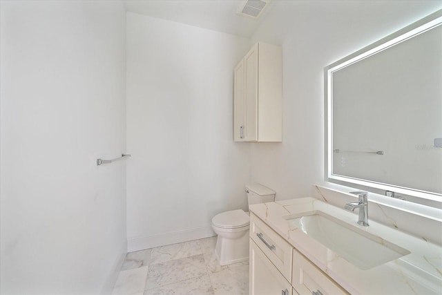 656 Tropical Cir, Sarasota, FL 34242 - bathroom with visible vents, baseboards, vanity, toilet, and marble finish floor