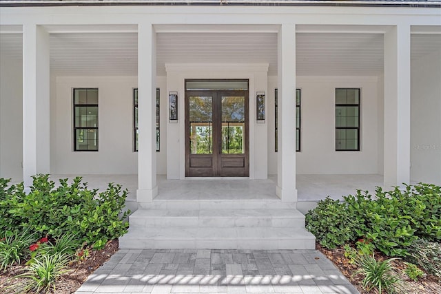 656 Tropical Cir, Sarasota, FL 34242 - property entrance featuring a porch and stucco siding