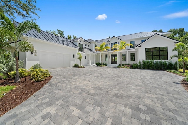 656 Tropical Cir, Sarasota, FL 34242 - modern farmhouse style home featuring a standing seam roof, stucco siding, decorative driveway, and metal roof