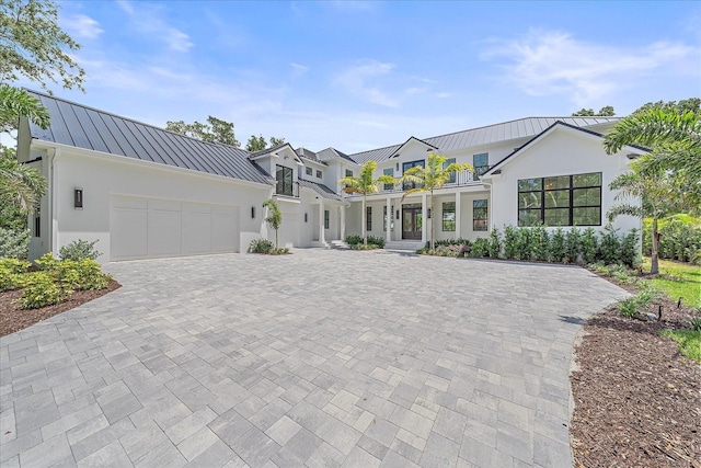 656 Tropical Cir, Sarasota, FL 34242 - modern farmhouse with a standing seam roof, stucco siding, and metal roof