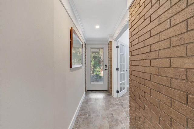 hall with crown molding and brick wall