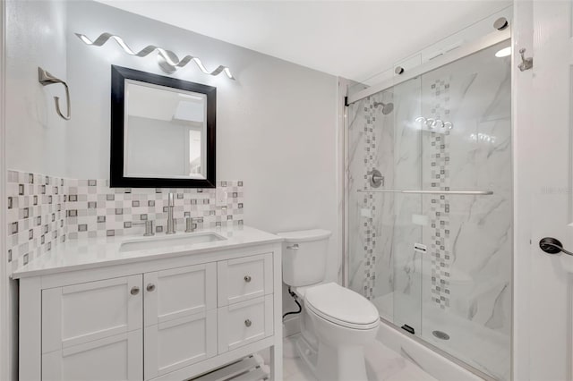 bathroom with tasteful backsplash, vanity, toilet, and walk in shower