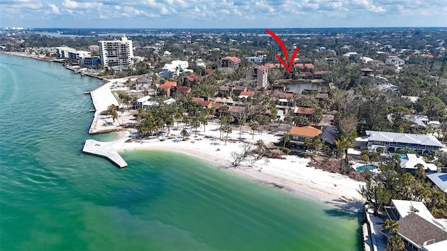 drone / aerial view featuring a view of the beach and a water view